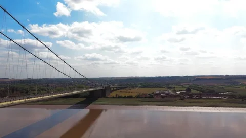 Aerial view of a large suspension bridge spanning a wide river 库存影片 343545700