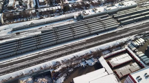 Aerial view of a large train depot with multiple tracks and passenger cars next 動画素材 331148804