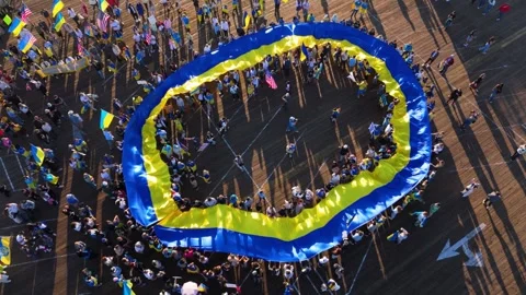 Aerial View of a Large Ukrainian Flag Unfurled on Santa Monica Pier, USA Stock Footage 304729220