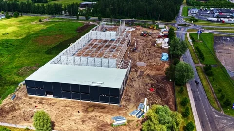 Aerial view of a large warehouse construction site with steel framing and Stock Footage 342977767