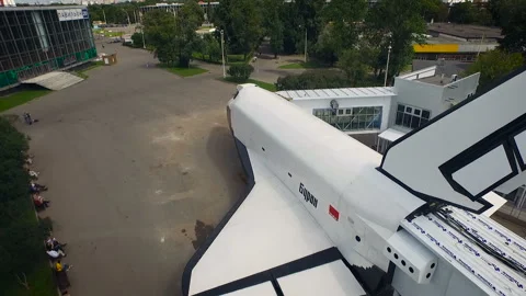Aerial view large white plane in the city park. A lot of people in the park take Stock Footage 93591390