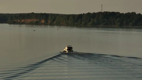 Aerial view. A large white private motor yacht floats on a calm river at sunset. Video stock 234466945