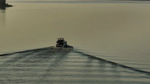 Aerial view. A large white private motor yacht floats on a calm river at sunset. Stock-Footage 234468220