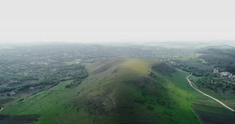 Aerial view of a large, white, steep, natural quarry with a lonely tree on to Stock Footage 135026185