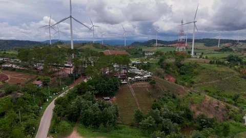 Aerial view of large wind turbines spinning over green rolling hills in rur.. Stock Footage 337471569