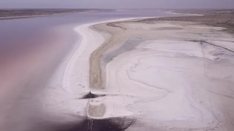 Aerial view of layer of white salt deposits and therapeutic mud in coastal zone Stock Footage 195932526