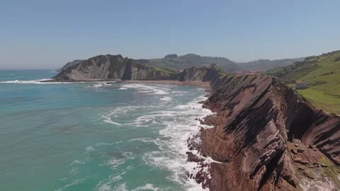 Aerial view of layered flysch cliffs and breaking waves Stockbeeldmateriaal 343324437