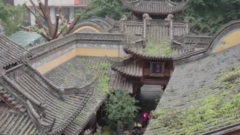 Aerial view of layered grey tile rooftops and courtyard at Luohan Temple Stock Footage 332137493