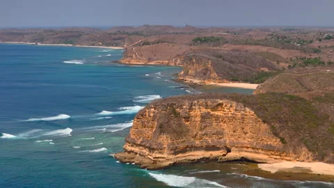 Aerial view of layered sea cliffs and remote tropical bays Stockbeeldmateriaal 333295757
