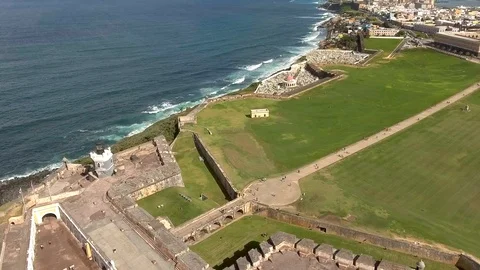 Aerial view leaving El Morro towards La Perla and ocean in San Juan, Puerto Rico Stock Footage 98275261