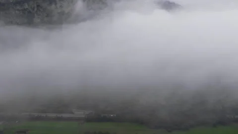 Aerial view of left to right slow drone motion in misty Dolomites Austria at Stock Footage 263846546