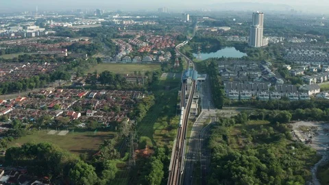 Aerial view of a Light Rail Transit (LRT) running through the residential areas Stock Footage 127012530