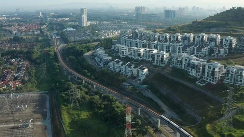 Aerial view of a Light Rail Transit (LRT) running through the residential areas Stock Footage 127013268