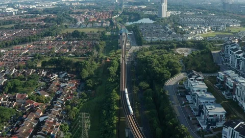 Aerial view of a Light Rail Transit (LRT) running through the residential areas Stock Footage 127015785
