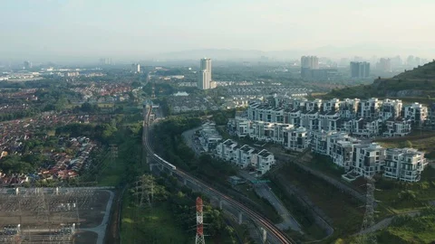 Aerial view of a Light Rail Transit (LRT) running through the residential areas Stock Footage 127023196