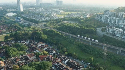 Aerial view of a Light Rail Transit (LRT) running through the residential areas Stock Footage 127030524