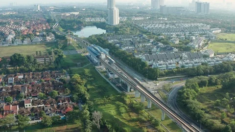 Aerial view of a Light Rail Transit (LRT) running through the residential areas Stock Footage 127031443