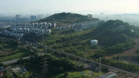 Aerial view of a Light Rail Transit (LRT) running through the residential areas Stock Footage 127037641