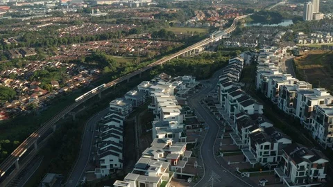 Aerial view of a Light Rail Transit (LRT) running through the residential areas Stock Footage 127330104
