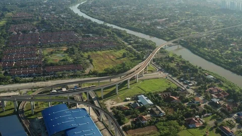 Aerial view of a Light Rail Transit (LRT) running through the residential areas Stock Footage 127330281