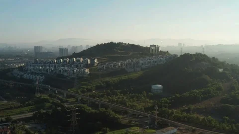 Aerial view of a Light Rail Transit (LRT) running through the residential areas Stock Footage 127333680