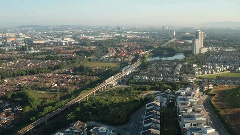 Aerial view of a Light Rail Transit (LRT) running through the residential areas Stock Footage 127333807