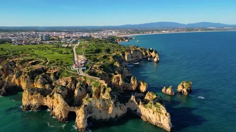 Aerial View on Lighthouse and Cliffs in Lagos Algarve Portugal Video stock 332344500