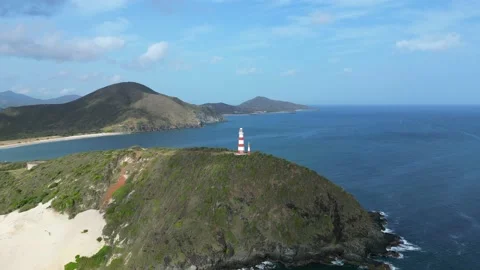 Aerial view of lighthouse on a cliff of the seashore, popular tourist landmark Stock Footage 225311575
