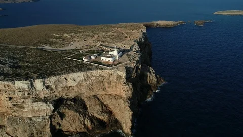Aerial view of lighthouse on the edge of a cliff Stock Footage 116619365