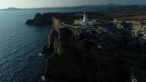 Aerial view of lighthouse on the edge of a cliff Stock Footage 116619394