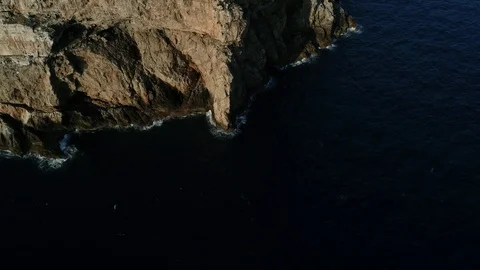 Aerial view of lighthouse on the edge of a cliff Stock Footage 116619584
