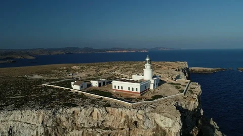 Aerial view of lighthouse on the edge of a cliff Stock Footage 119881289