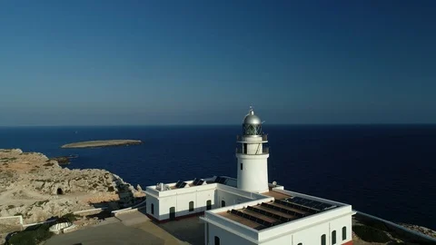 Aerial view of lighthouse on the edge of a cliff Stock Footage 119881290