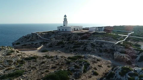 Aerial view of lighthouse on the edge of a cliff Stock Footage 119881309
