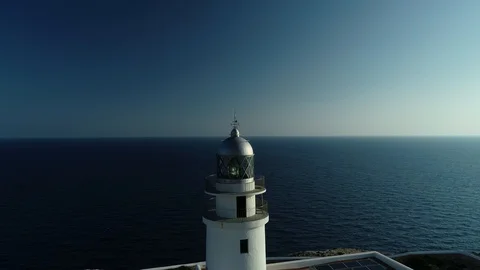 Aerial view of lighthouse on the edge of a cliff Stock Footage 119881333