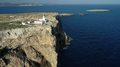 Aerial view of lighthouse on the edge of a cliff Stock Footage 119881386