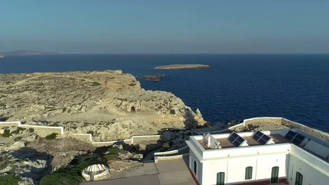 Aerial view of lighthouse on the edge of a cliff Stock Footage 119881394
