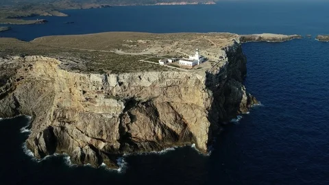 Aerial view of lighthouse on the edge of a cliff Stock Footage 119881408