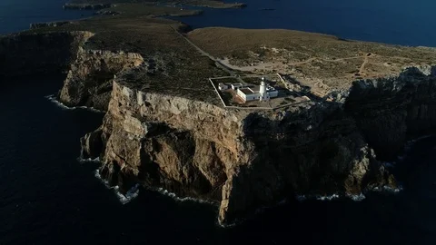 Aerial view of lighthouse on the edge of a cliff Stock Footage 119881418