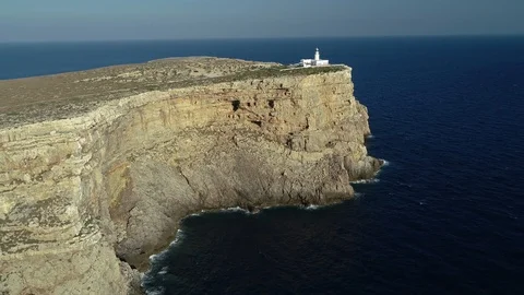 Aerial view of lighthouse on the edge of a cliff Stock Footage 120297946