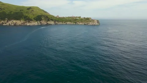 Aerial view, Lighthouse Gamow, Pacific Ocean, rocks,grass on the mountain Stock-Footage 162640893