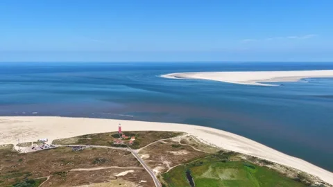 Aerial view of a lighthouse on the island Texel with Vlieland in the distance Video stock 345054681
