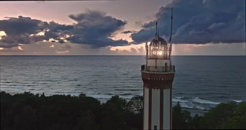 Aerial view of lighthouse with light beam by Baltic Sea. Stock Footage 300000491