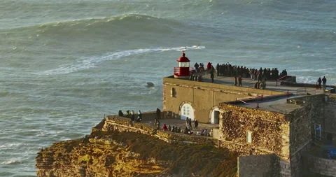 Aerial view of the lighthouse located on a huge cliff and offering a view of the 스톡 동영상 308976367