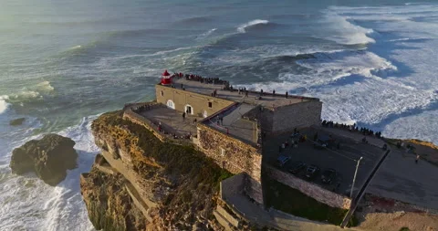 Aerial view of the lighthouse located on a huge cliff and offering a view of the Stock-Footage 311113809