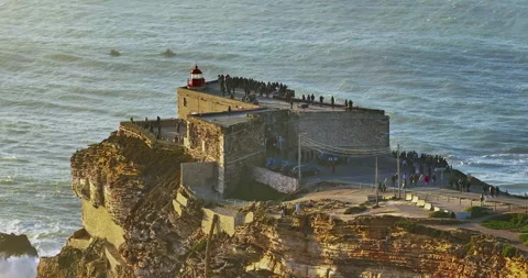 Aerial view of the lighthouse located on a huge cliff and offering a view of the Stock Footage 311499543