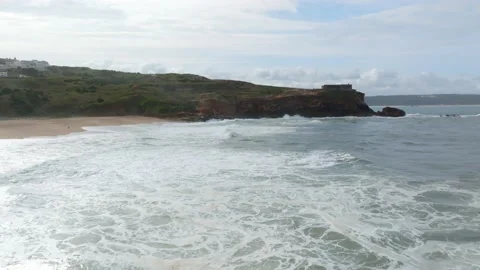 Aerial view of a lighthouse perched on the edge of a cliff at Nazare, Portu.. Stock Footage 239577715