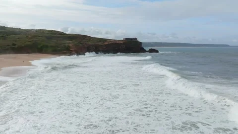 Aerial view of a lighthouse perched on the edge of a cliff at Nazare, Portu.. Stock Footage 239578084