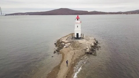 Aerial view lighthouse in sea on background suspension bridge and city landscape Stock Footage 92539905