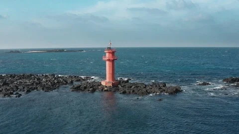 Aerial view. A lighthouse standing in the middle of the sea like an island. Dron Stock Footage 122270934